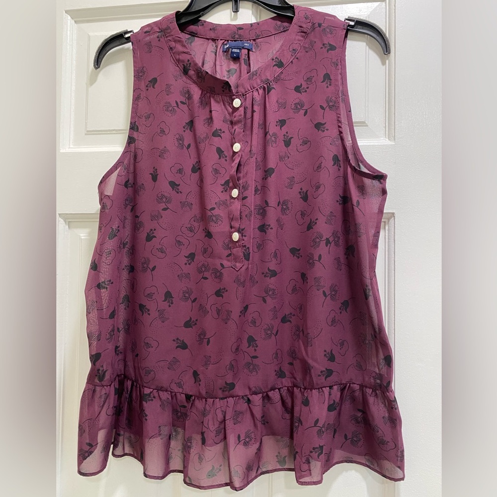 Sheer sleeveless burgundy and black woman’s blouse by gap, size large.